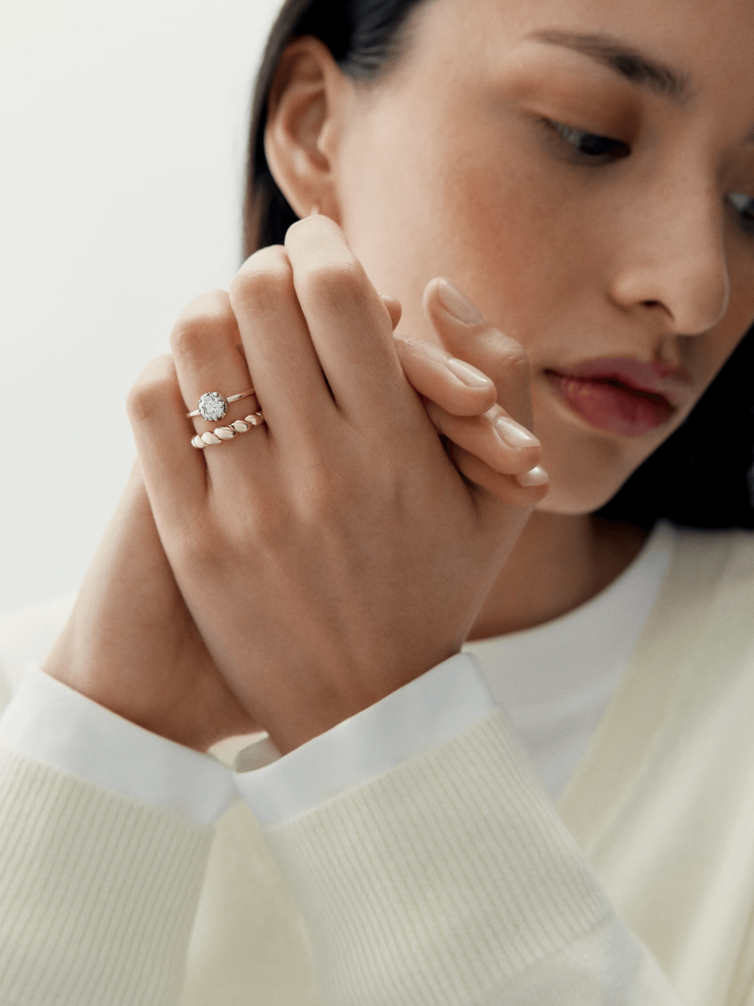Close-up of a woman wearing an elegant diamond and white gold ring crafted with traditional techniques, showcasing a contemporary yet antique-inspired design. View 3