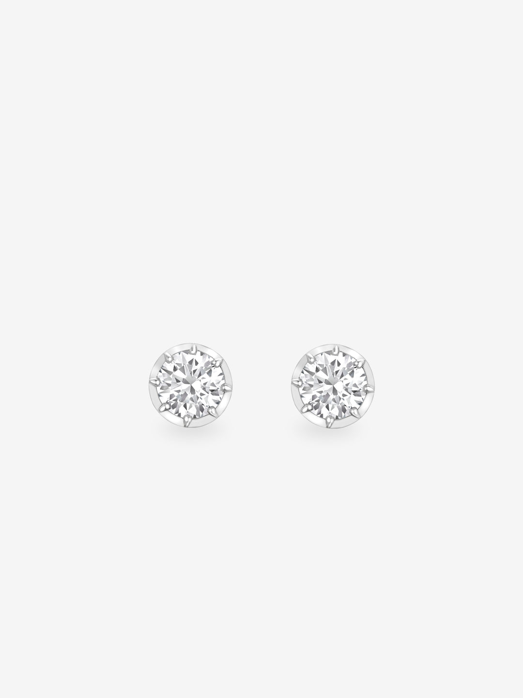 Pair of round brilliant cut diamond stud earrings set in white gold, showcasing timeless craftsmanship with a contemporary, antique-inspired design.  View 1