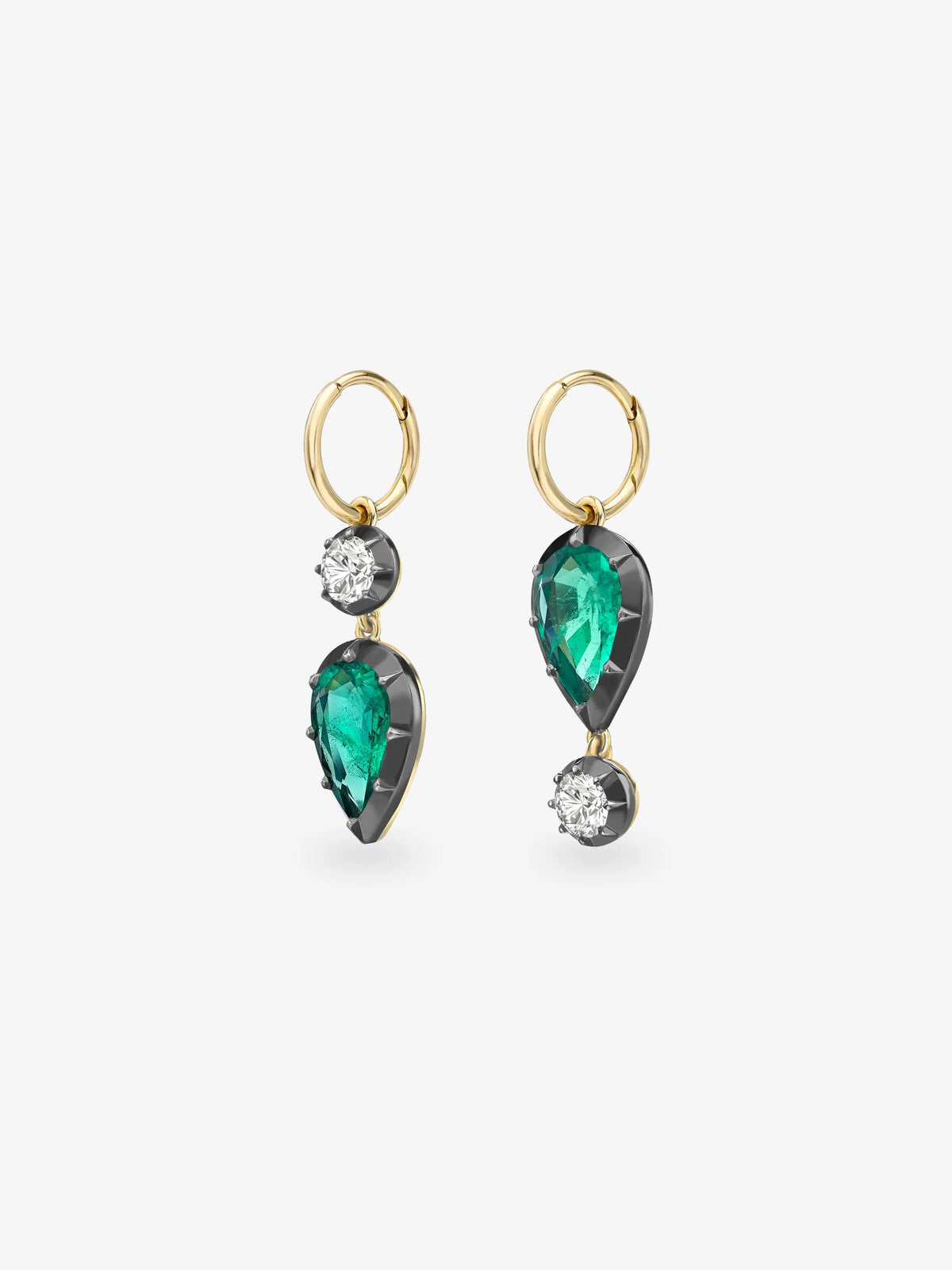Asymmetric gold hoop earrings with pear shaped emeralds, round diamonds and dark contrasting settings, showcasing contemporary gypset craftsmanship View 2