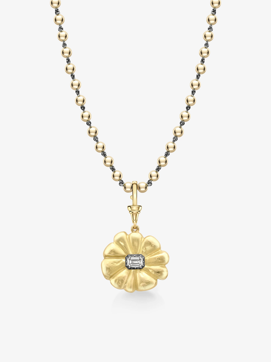 Delicate yellow gold pendant shaped like a flower with a central emerald-cut diamond, hanging from a matching beaded chain, blending antique charm with modern elegance. View 4