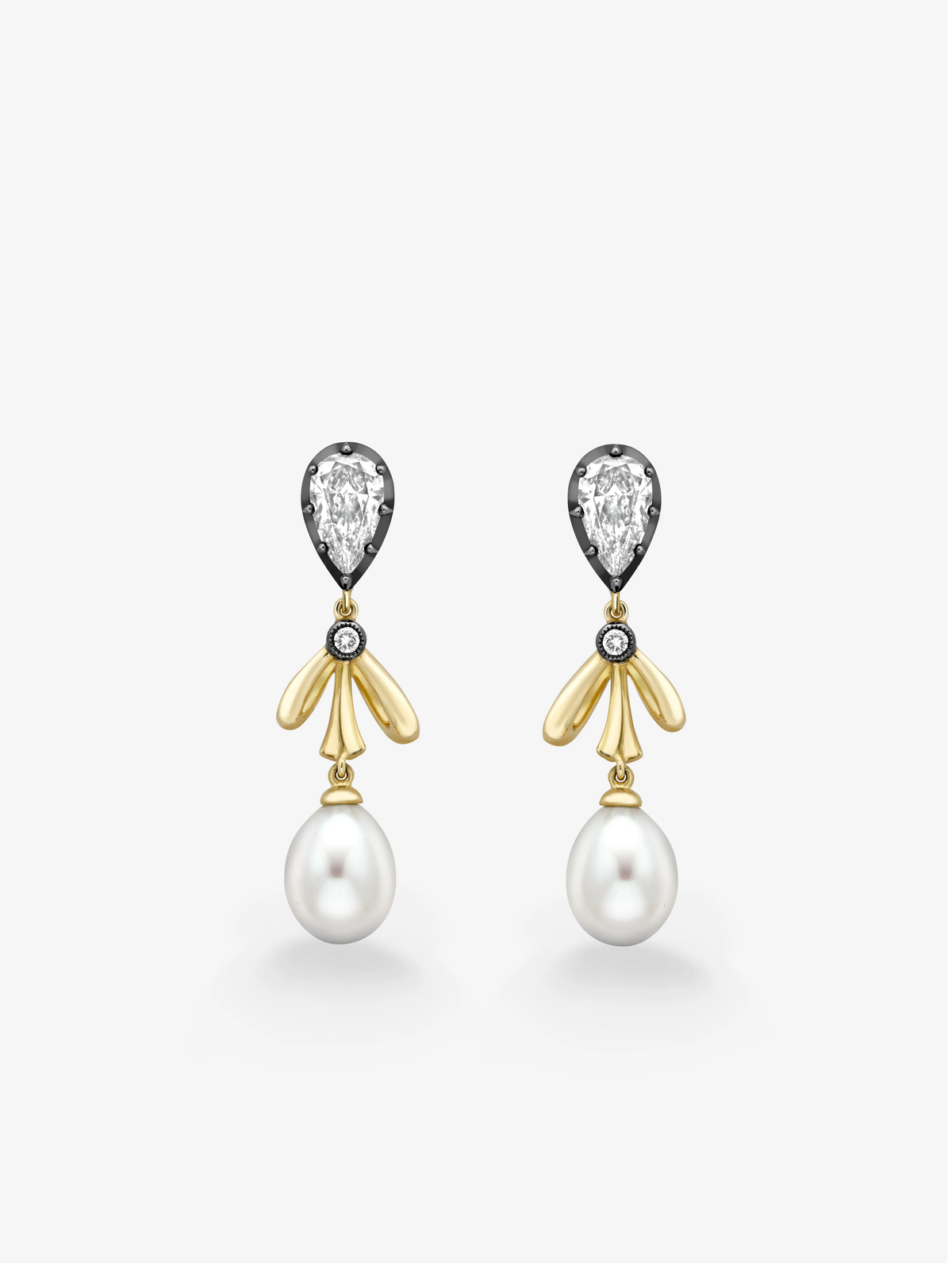 Pear-shaped diamond, yellow gold and pearl drop earrings with sculptural bow details, shown as a matching pair on a white background. View 1
