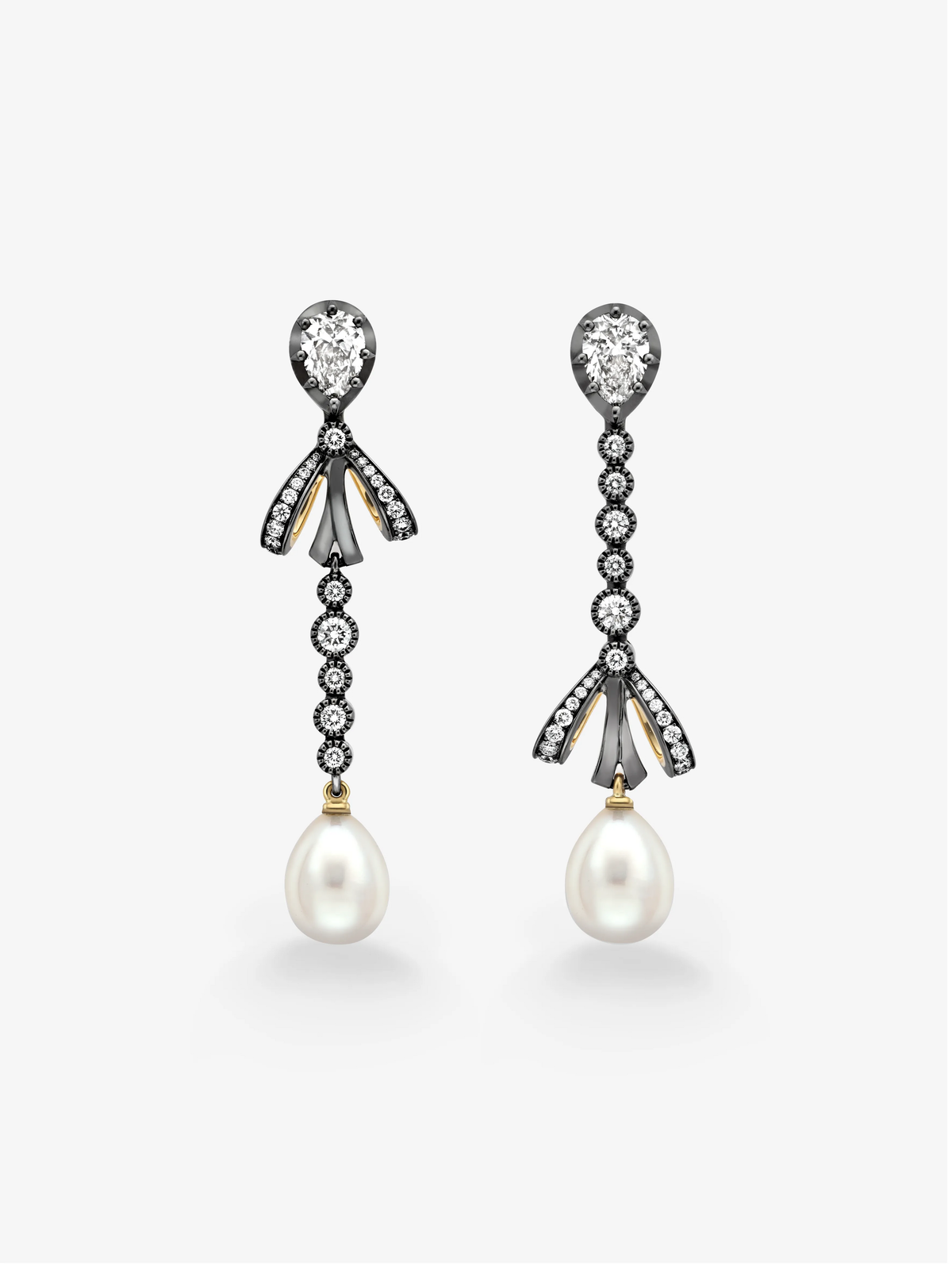 Asymmetric diamond and pearl drop earrings with bow details and graduated diamond links, shown against a white background View 1
