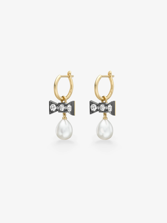 Gold hoop earrings with diamond set bow details and dangling white pearls on a white background View 2