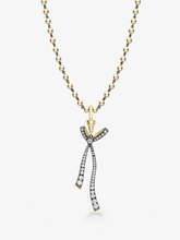 Jessica McCormack diamond necklace with a gold ball and chain and detachable ribbon bow pendant set with diamonds in contrasting blackened and yellow gold
