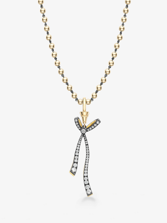 Jessica McCormack diamond necklace with a gold ball and chain and detachable ribbon bow pendant set with diamonds in contrasting blackened and yellow gold View 2