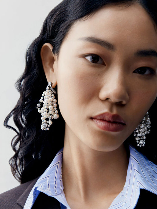 Jessica McCormack diamond and pearl clustered earrings worn by a model in a contemporary layered look View 3