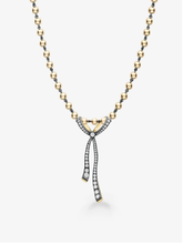 Diamond ribbon pendant necklace with a sculptural bow design, pavé diamond detailing, and a beaded two tone chain in gold and blackened metal