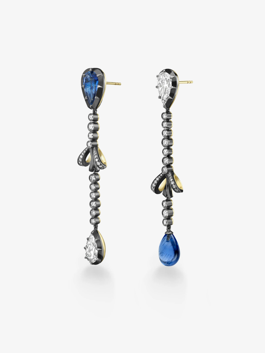 Asymmetric diamond and sapphire drop earrings with beaded chains, bow motifs, and contrasting blue sapphire and diamond drops View 2