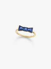 Gold bow sapphire ring featuring vivid blue sapphires and a polished rounded band, blending antique-inspired artistry with contemporary style