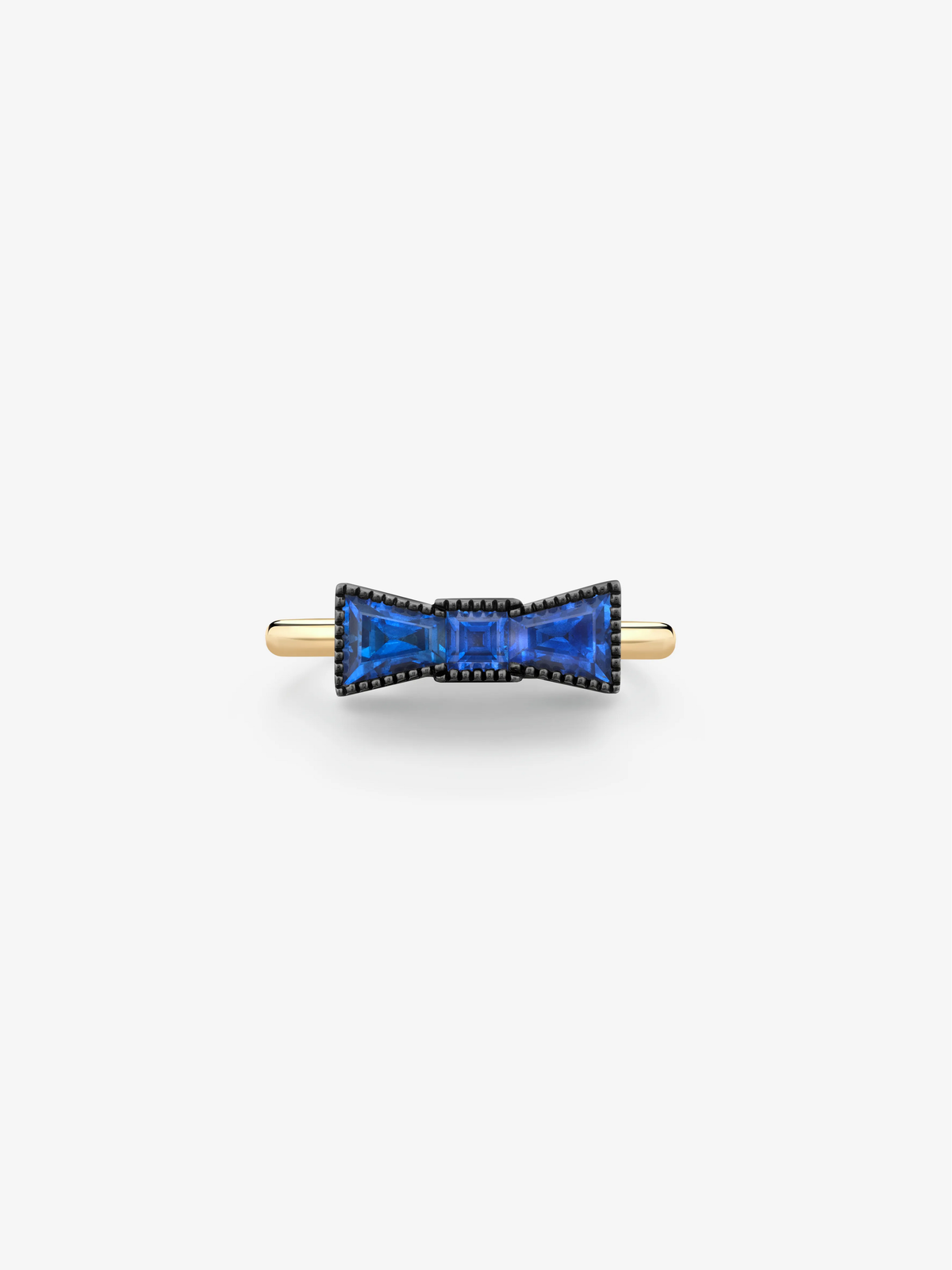 Bow-shaped sapphire ring with vivid blue sapphires framed by blackened gold detailing and set on a polished yellow gold band View 1