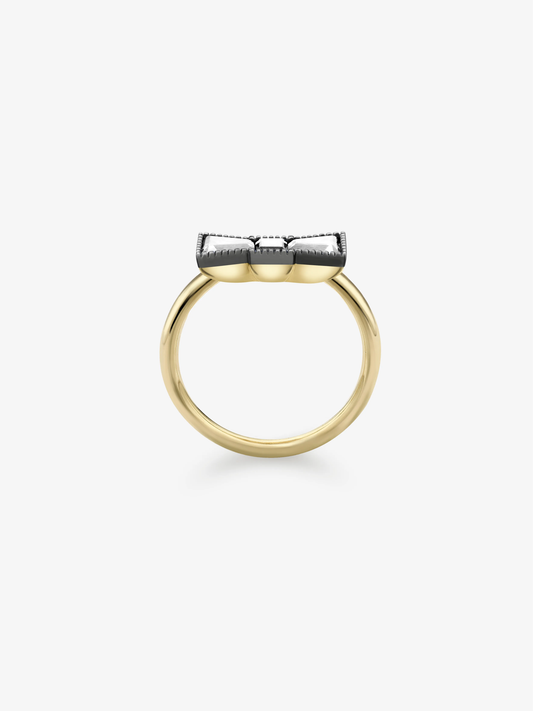 Side view of a diamond ring with a polished yellow gold band and raised blackened white gold bow-inspired setting, showcasing refined contemporary craftsmanship View 4