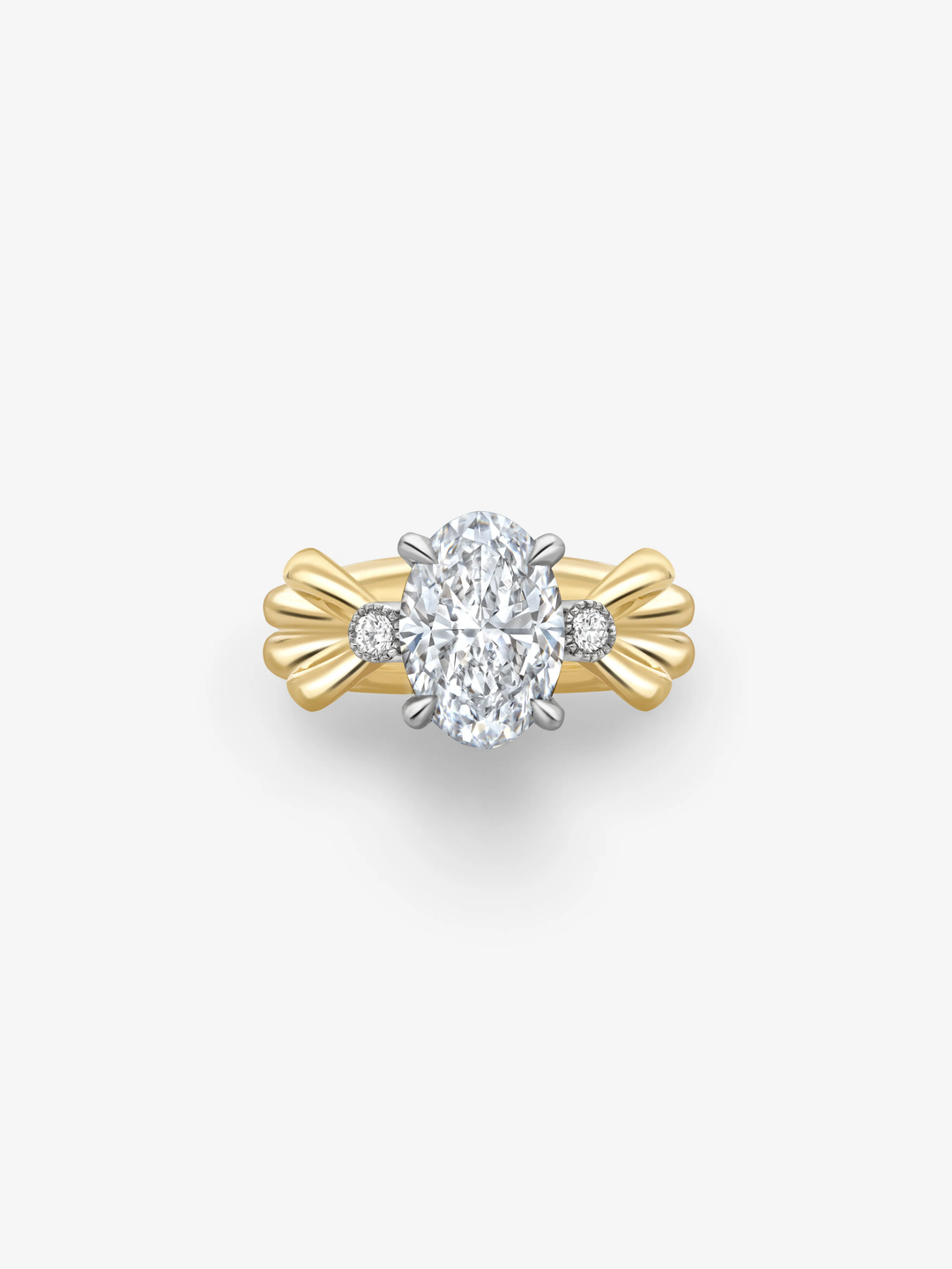 Oval cut diamond ring with a large central diamond, round side stones and sculptural yellow gold bow inspired shoulders.  View 1