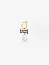 Jessica McCormack single gypset hoop earring in yellow gold with a diamond bow and lustrous pearl drop, blending antique inspired artistry with contemporary style