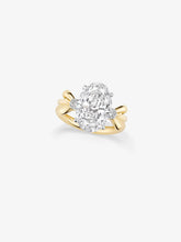 Jessica McCormack oval diamond ring with a large central oval stone, diamond accents and sculptural yellow gold bow details