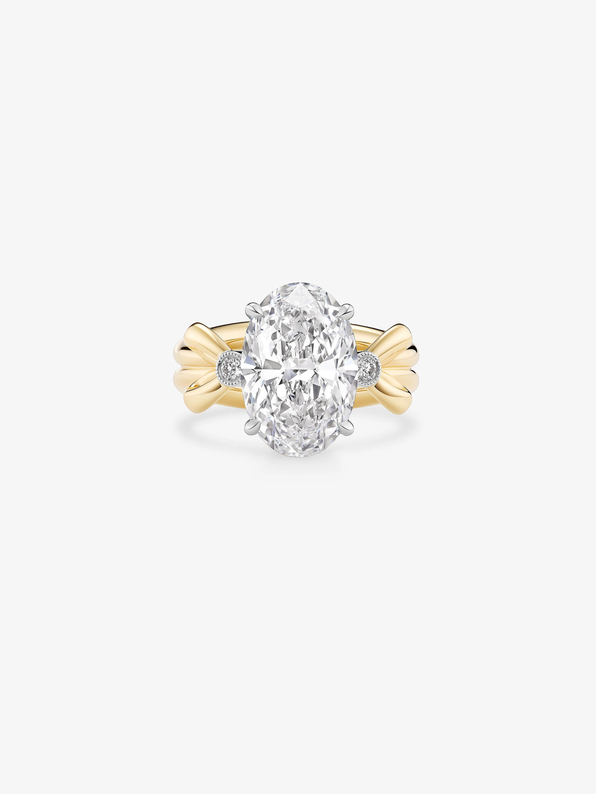Jessica McCormack oval diamond ring with a large oval cut centre diamond, round side diamonds and sculptural yellow gold bow motifs View 1