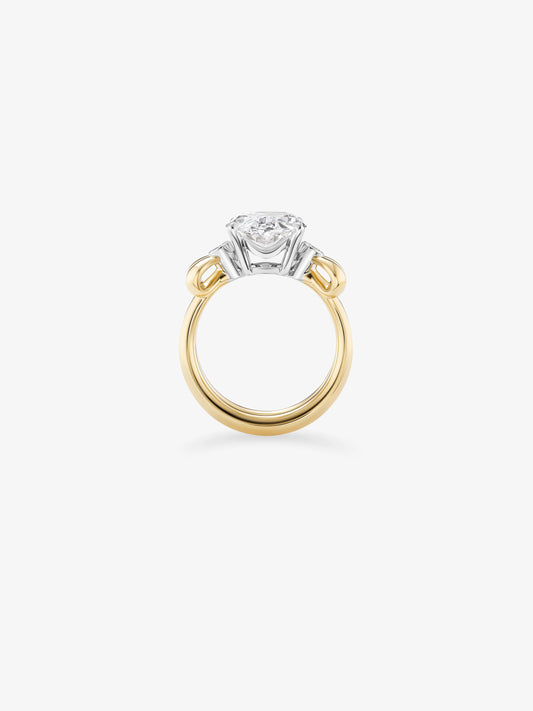 Oval diamond ring with a yellow gold band and contrasting white gold setting, shown from the side with a raised diamond and sculptural details View 3