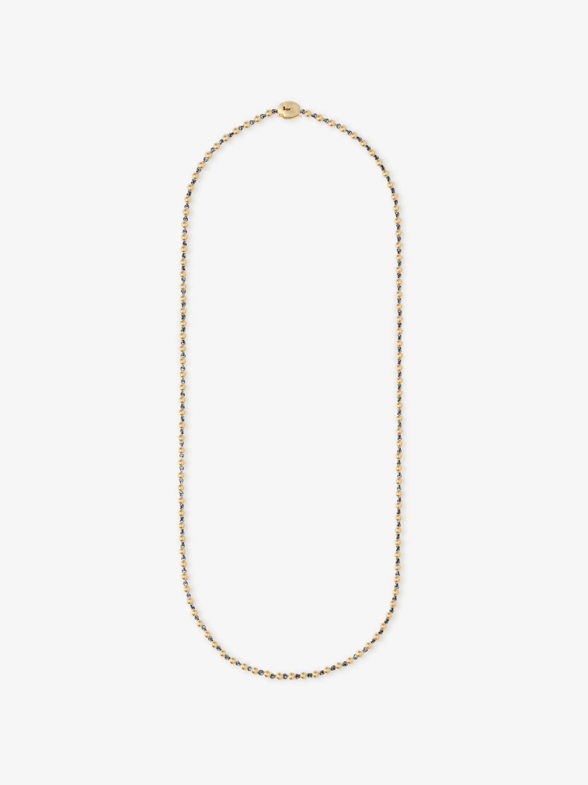 Delicate yellow gold micro ball and chain necklace featuring a minimalist design that blends traditional craftsmanship with contemporary elegance. View 1