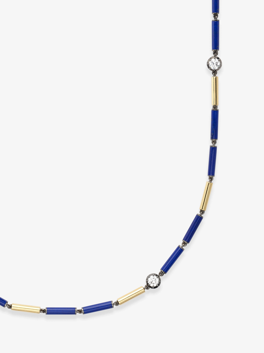 Delicate necklace featuring alternating blue lapis cylindrical beads and gold tubes accented with round brilliant diamonds, showcasing handcrafted artistry and contemporary design. View 2