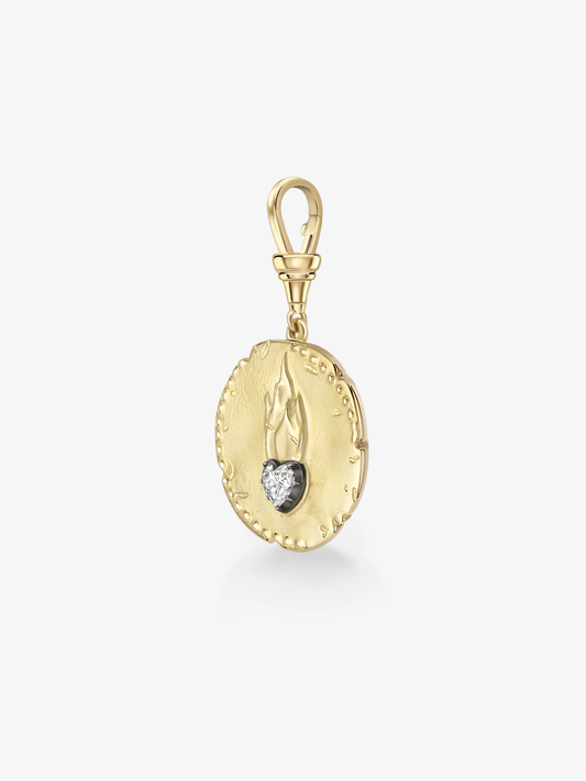 Oval gold pendant featuring a heart-shaped diamond set in blackened gold, designed with antique-inspired detailing and a swivel clasp. View 5