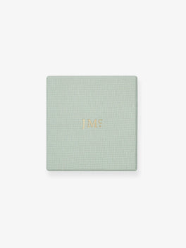 Light green textured jewelry box with subtle gold embossed initials, designed to elegantly present and protect fine contemporary diamond bracelets.