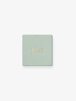 Mint green jewelry box with a gold JM monogram on the lid