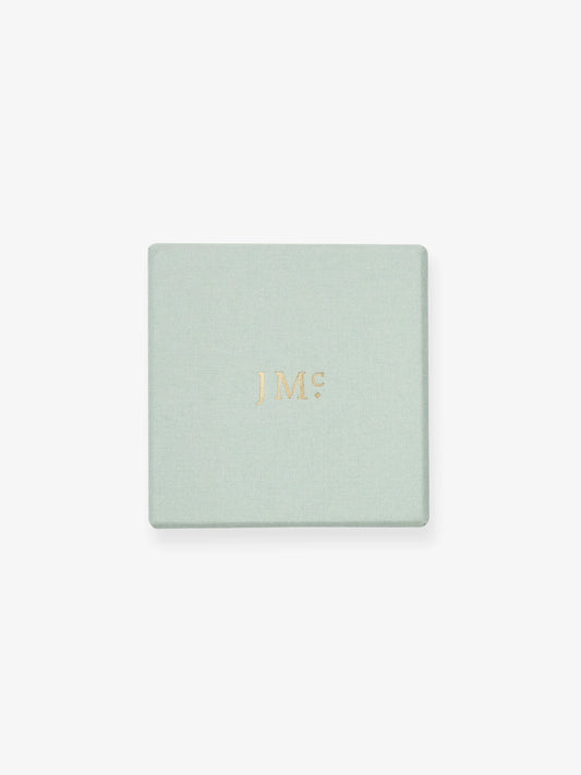 Light green luxury jewelry box with subtle gold foil Jessica McCormack initials, reflecting the brand’s blend of antique inspiration and contemporary elegance. View 2
