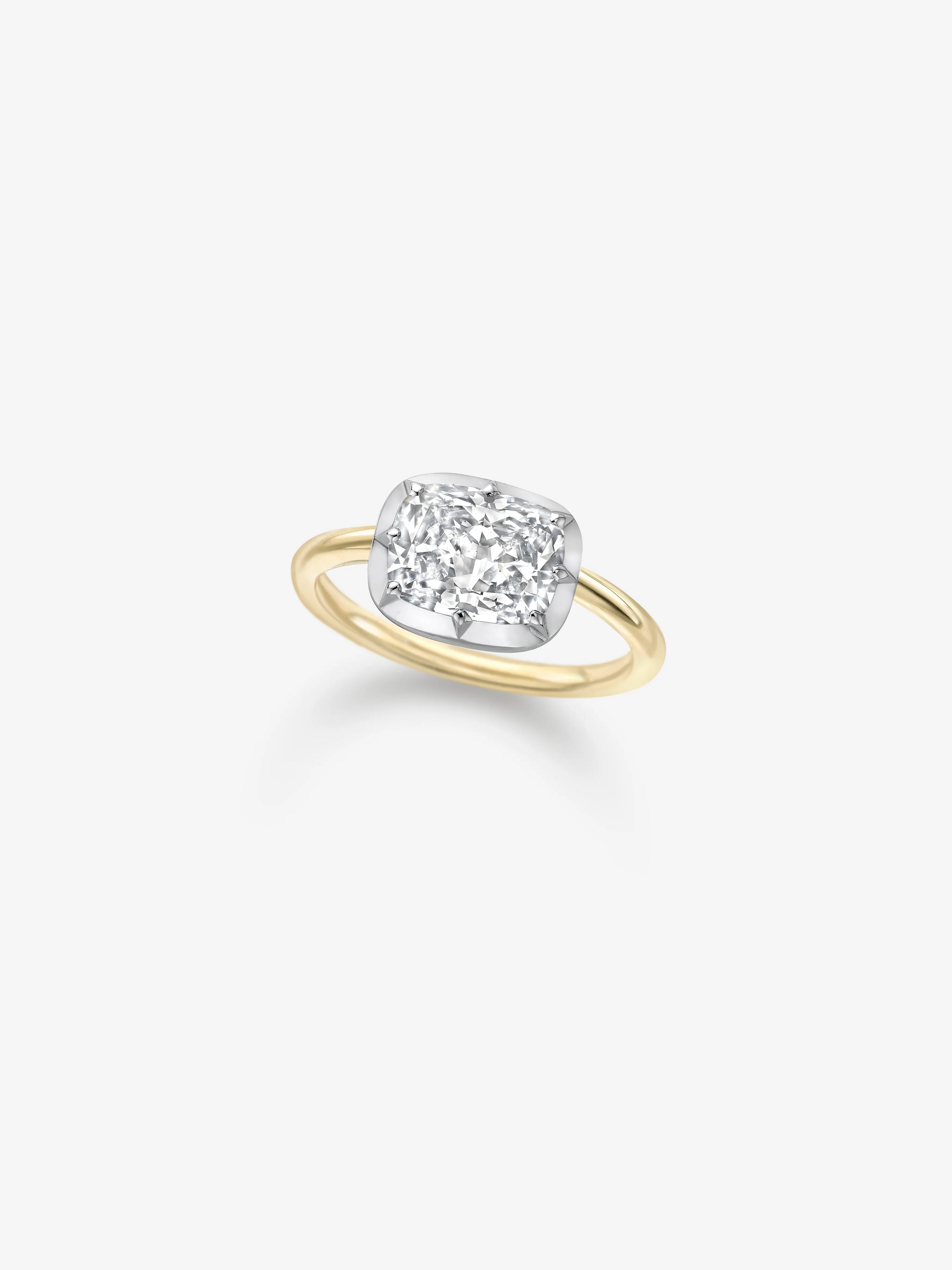 Contemporary ring featuring a cushion-shaped diamond set horizontally on a polished yellow gold band with a white gold button-back setting, blending antique-inspired craftsmanship with modern design. View 2