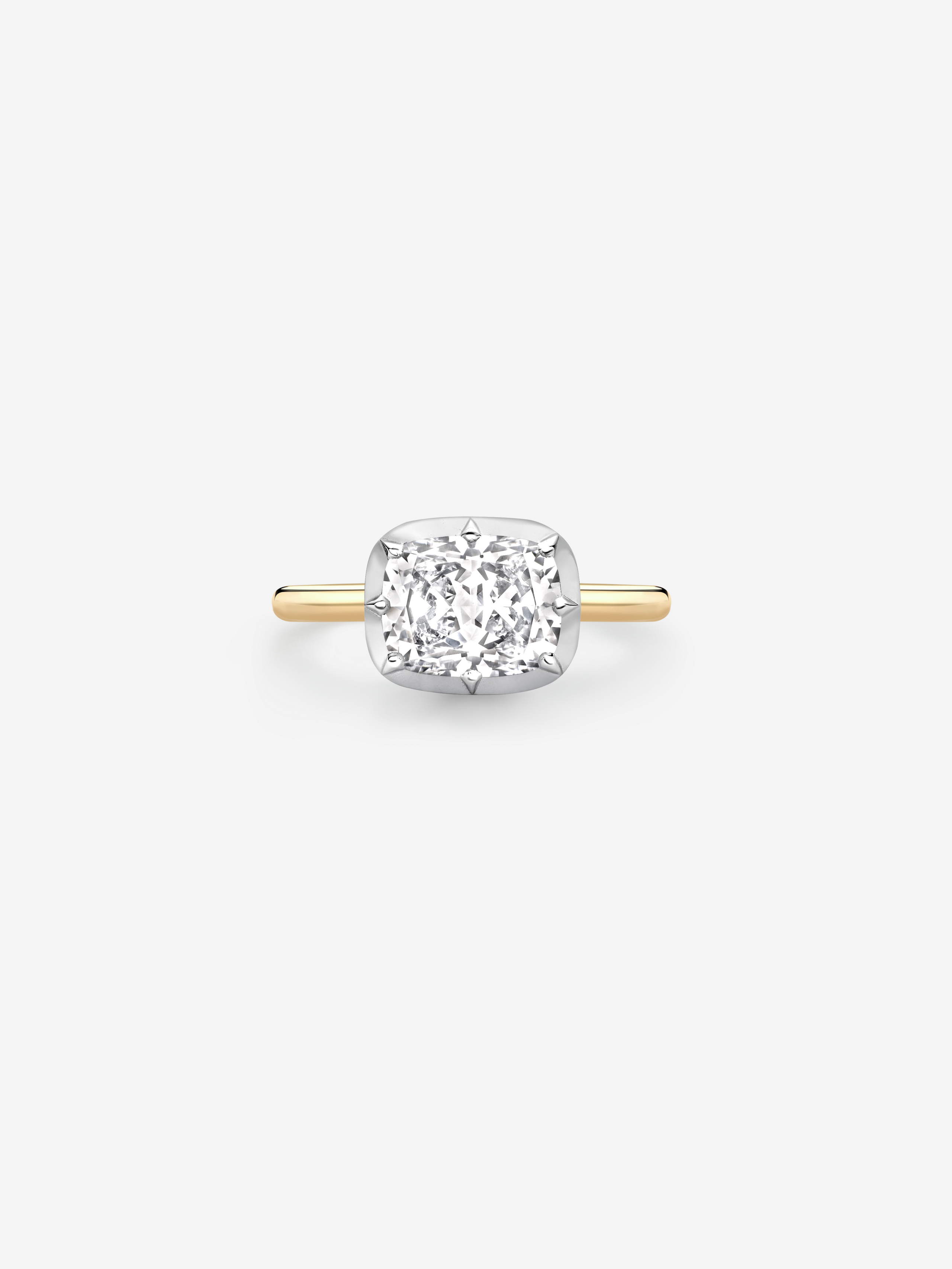 Delicate ring featuring a 2.01ct east-west cushion diamond set in a button back style with a slim yellow gold band, blending antique inspiration with contemporary design. View 1