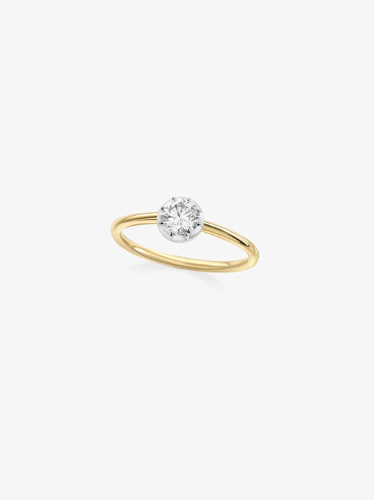 Delicate yellow gold ring featuring a round brilliant diamond set in a white gold button back, blending traditional craftsmanship with contemporary style. View 2
