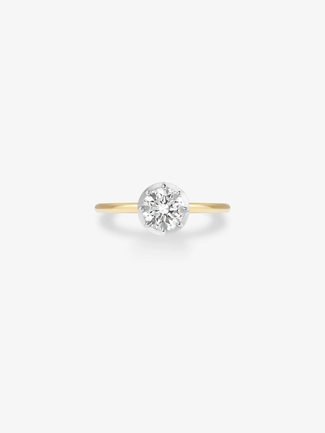 Delicate ring featuring a 0.90ct diamond set in a white gold button back setting on a slender yellow gold band, blending antique craftsmanship with modern elegance.  View 1