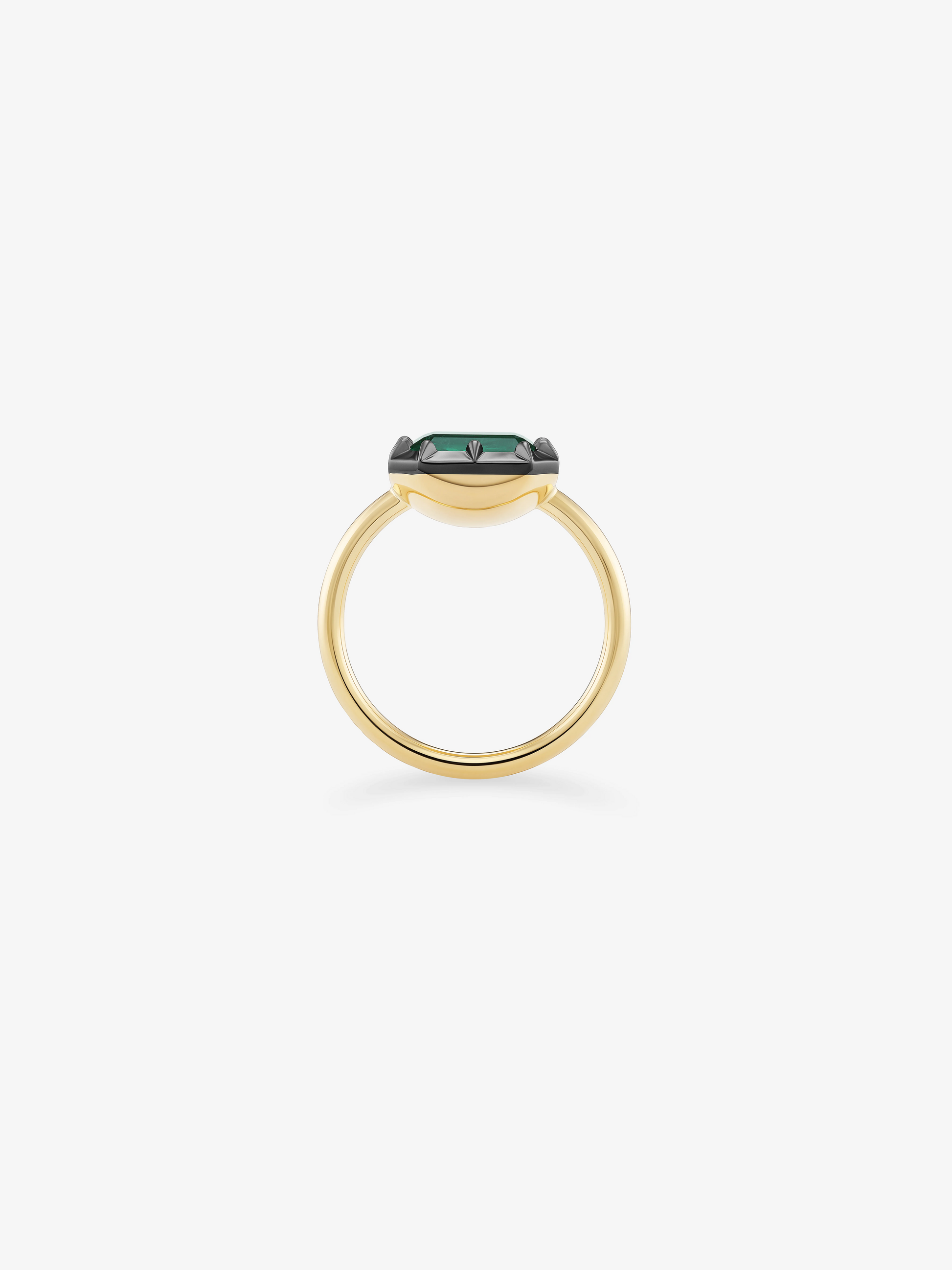 Yellow gold ring featuring a sleek emerald-cut green emerald set horizontally with blackened gold button back detailing, blending antique-inspired craftsmanship with modern design. View 3
